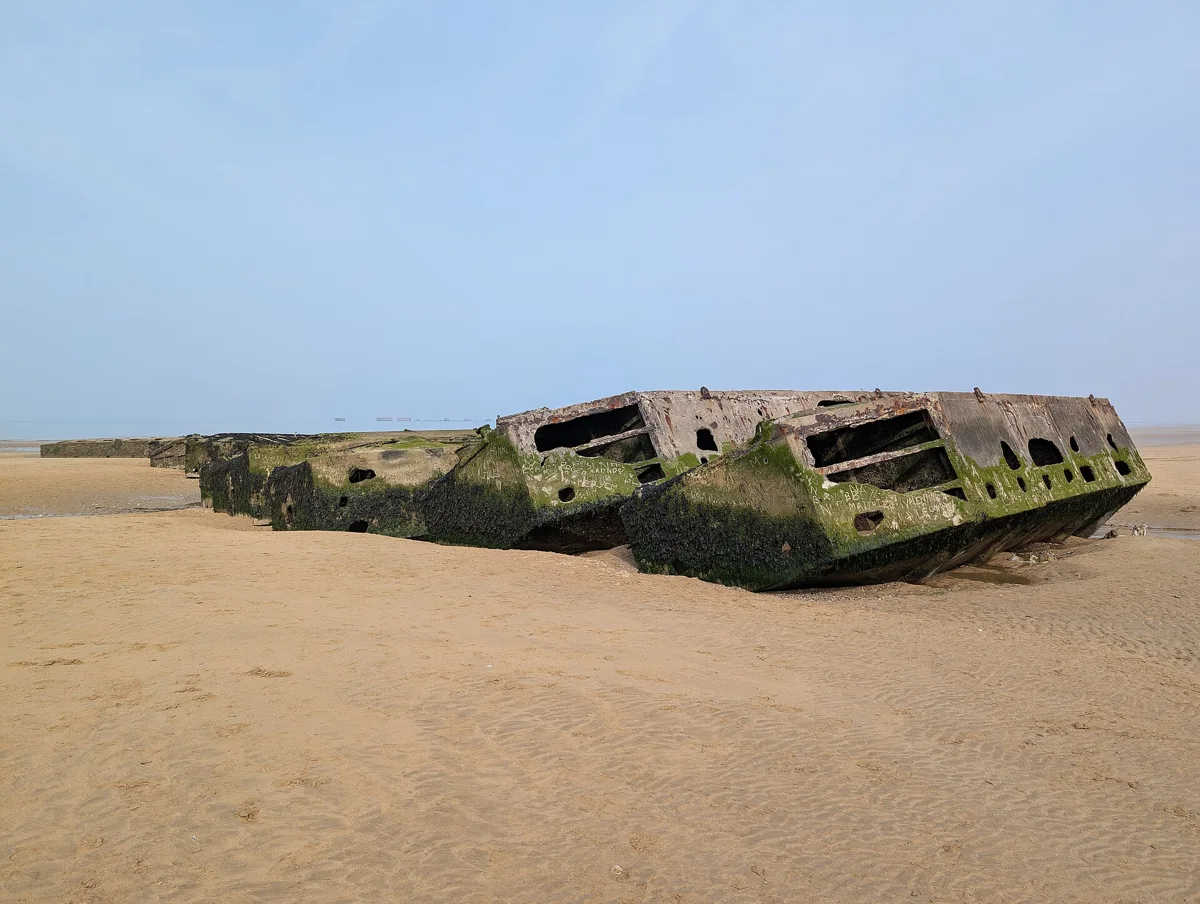 Mulberry Harbour concrete remains on Arromanches beach on a day trip from Paris to Normandy