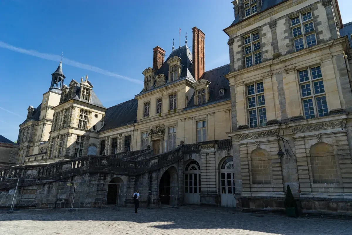 The horseshoe staircase courtyard of the Château de Fontainebleau on a day trip from Paris