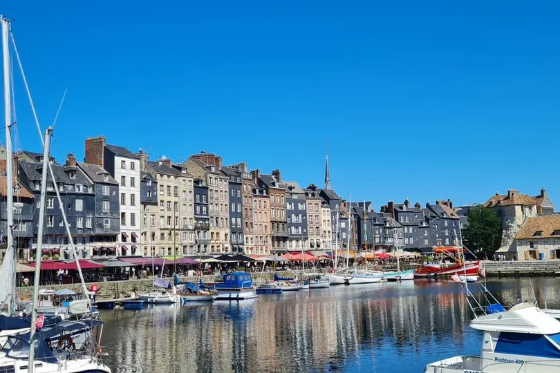 Boats and tall houses around the Vieux Bassin harbour in Honfleur on a three-day trip from Paris